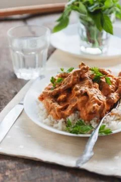 Dish rice with beef stroganoff on a white plate Stock Photos