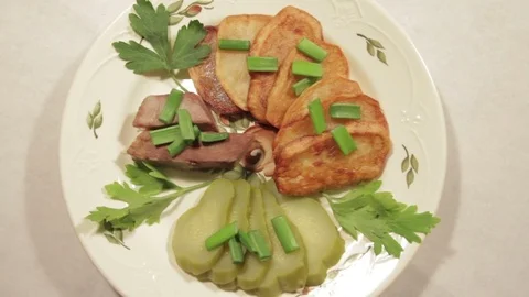 A dish of roasted potatoes with meat Stock Footage 70926571