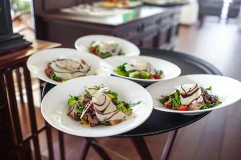 Dish on a round plate on the wedding table Stock Photos