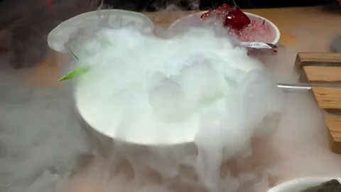 Dish served with dense dry ice fog on restaurant table. Stock Footage 332131600