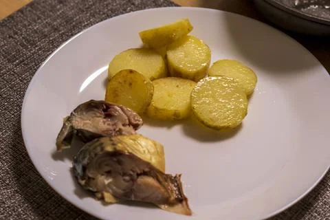 This dish serving of smocked mackerel and roasted potatoes. Food Stock Photos