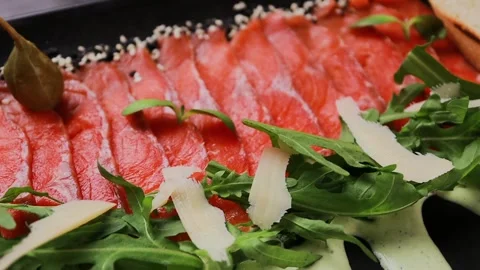 A dish of sliced red fish with sauce, herbs and bread Stock Footage 329231426