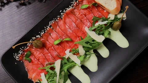 A dish of sliced red fish with sauce, herbs and bread Stock Footage 329231430