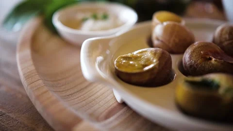 Dish of snails on a plate Stock Footage 132622264