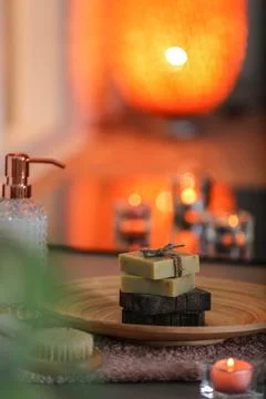 Dish with soap bars on table against blurred background. Space for text Foto stock