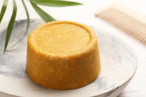Dish with solid shampoo bar on table, closeup 写真素材