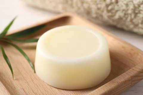 Dish with solid shampoo bar on white table, closeup 스톡 사진
