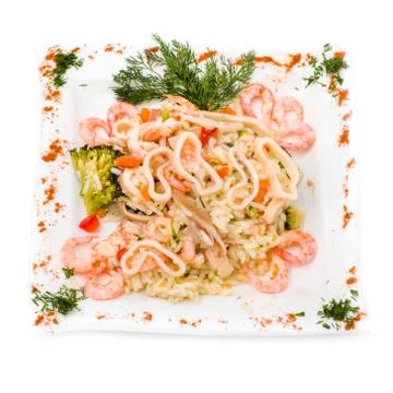 Dish with squid, shrimp, rice and vegetables Stock Photos