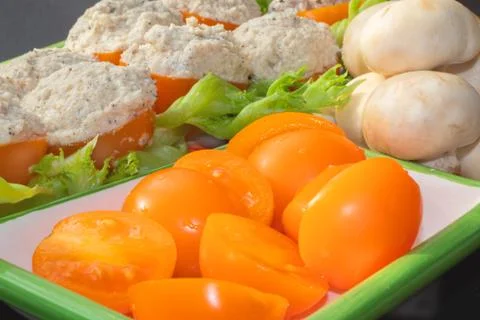 Dish for vegetarians, tomatoes stuffed with chapignons. Stock Photos