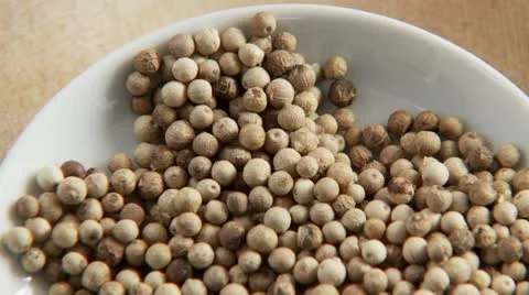 A dish of white peppercorns Stock Footage 24635011