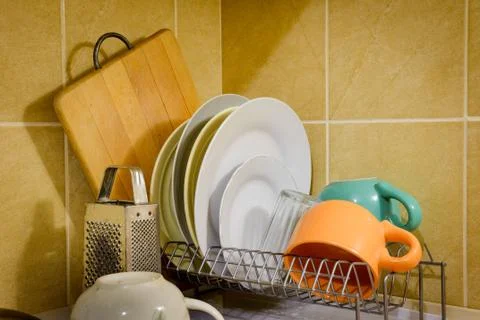 Dishes and Tableware Drying in Kitchen Фото