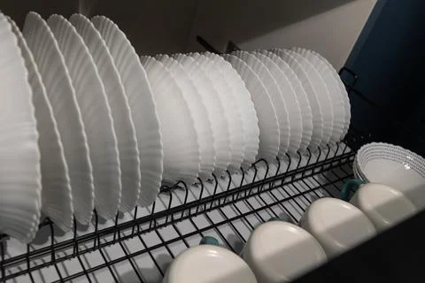 Dishes Drying in a Kitchen Rack After a Wash in a Modern Home Stock Photos