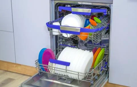 Dishware (plates) inside built-in dishwasher. Dishwashing machine rack Stock Photos