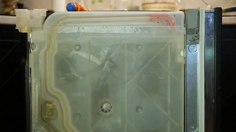 Dishwasher being fixed. Checking water circulation inside the machine. Sideview. Stock Footage 123604974