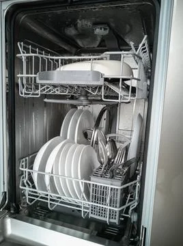 Dishwasher with clean dishes. Cleaning and cleanliness concept. Stock Photos