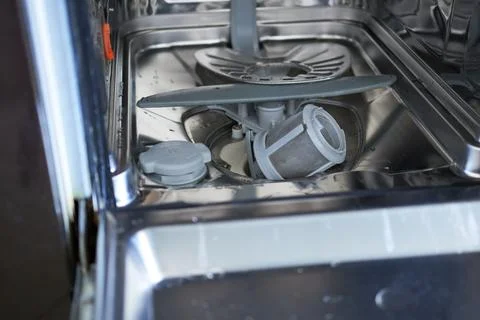 Dishwasher filter in the bottom of the dishwasher. Stock Photos