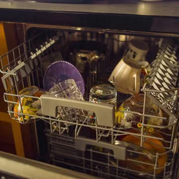 Dishwasher full of clean dishware Photos