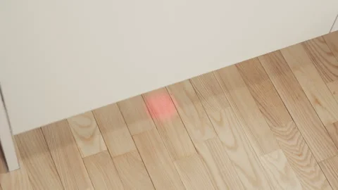 Dishwasher indicator: Careful alignment check of laser dot on wooden floor with Stock Footage 334706778
