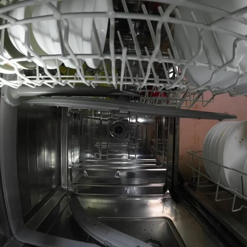 Dishwasher inside view dirty dish rack slides in square video Stock Footage 323187093