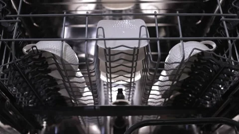 Dishwasher loading process showing plates arranged in racks, highlighting the Video stock 324295541