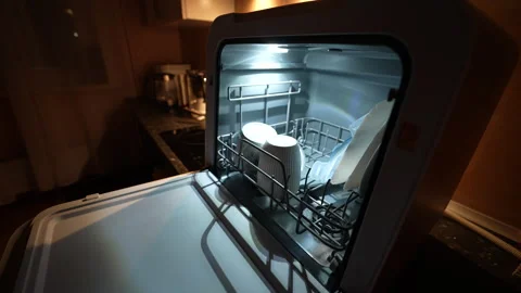 Dishwasher open at night, interior lit by soft glow 스톡 동영상 326059732