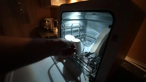 Dishwasher open at night, interior lit by soft glow 스톡 동영상 326059737