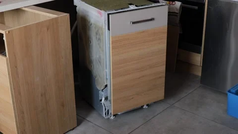 Dishwasher pulled out from kitchen cabinet for repair. Broken appliance bei.. Stock Footage 318903812
