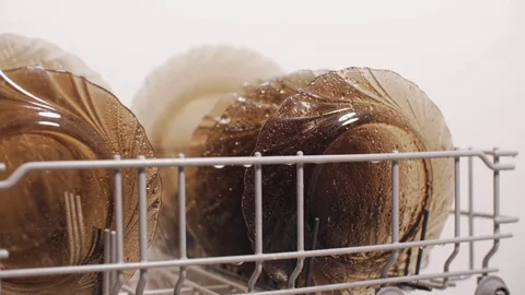 Dishwasher washes plates by spray of clean water in slow motion Stock Footage 83591850