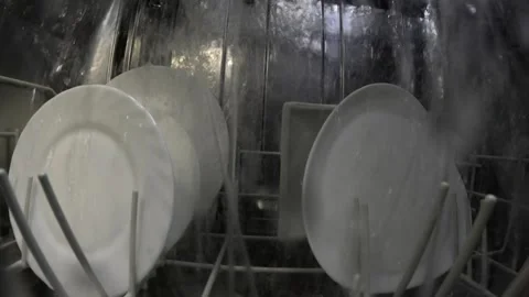 The dishwasher's function is to clean soiled dishes. The dishwasher uses a Video stock 297295629