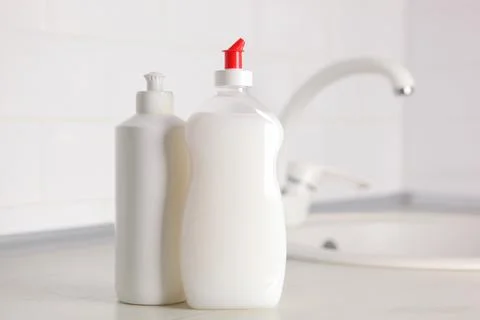 Dishwashing detergent on the background of the kitchen Stock Photos