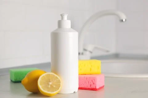 Dishwashing detergent on the background of the kitchen Stock Photos