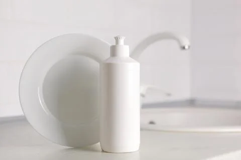 Dishwashing detergent on the background of the kitchen Stock Photos