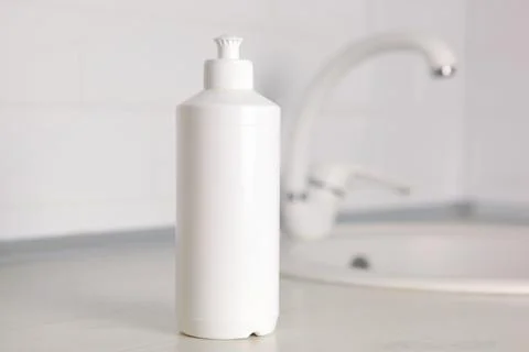 Dishwashing detergent on the background of the kitchen Stock Photos