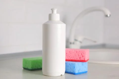 Dishwashing detergent on the background of the kitchen Stock Photos
