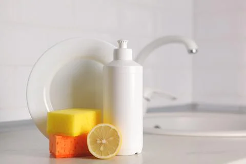 Dishwashing detergent on the background of the kitchen Stock Photos