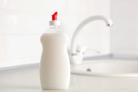 Dishwashing detergent on the background of the kitchen Stock Photos