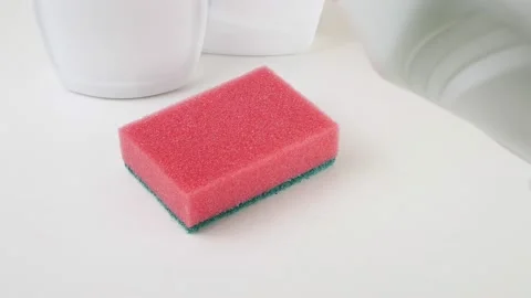 Dishwashing detergent flows to the sponge.Foam sponge on a white table. 스톡 동영상 130804607