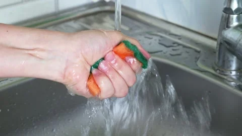 Dishwashing kitchen sponge in the hand close up Stock Footage 242801866