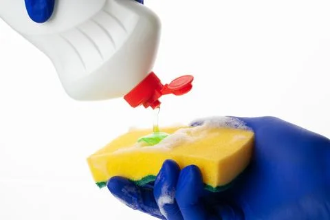 The dishwashing liquid flows onto the sponge. Sponge for washing and cleaning. Stock Photos