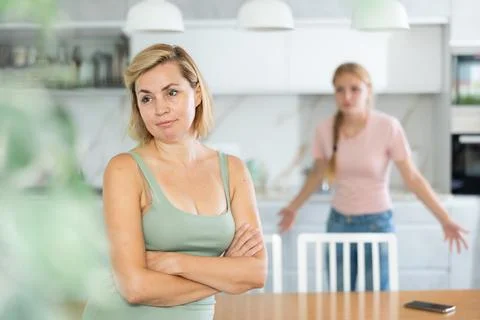 Disillusioned woman facing relationship problems with teenage daughter Stock Photos