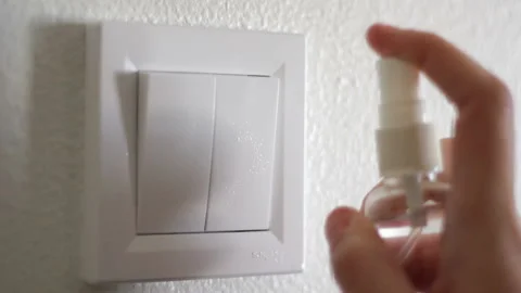 Disinfect and clean light switch with alcohol. Germs, bacteria, Covid-19 Cont Vídeo Stock 130029941
