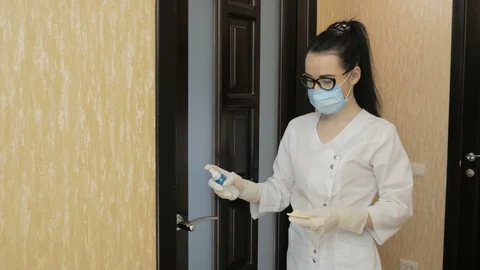 Disinfect the door handle with antibacterial solution in hospital quarantine Stock Footage 126862069