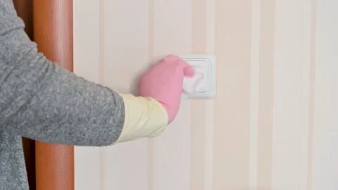 Disinfecting light switch against covid UHD Stock Footage 168767959