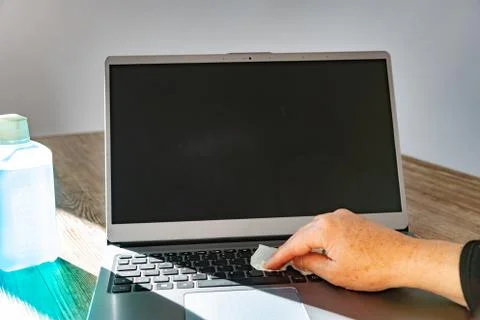 Disinfecting a notebook Foto stock