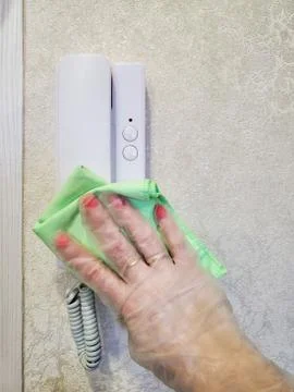 Disinfection of the intercom. Fighting the spread of the coronavirus, the Stock Photos