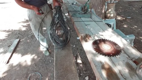 Disk for the angle grinder on the table. She cuts the wires. Stock Footage 77413314