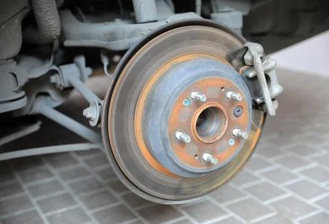 Disk brake and caliper in process of new tire replacement Stock Photos