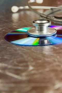 Disk CD and stethoscope Stock Photos
