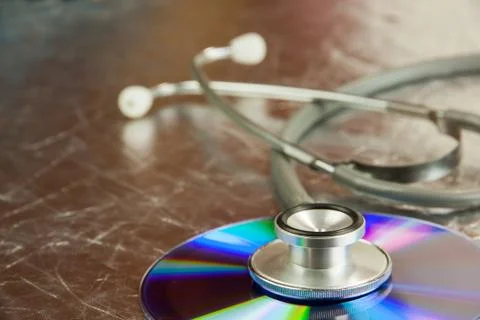 Disk CD and stethoscope Stock Photos