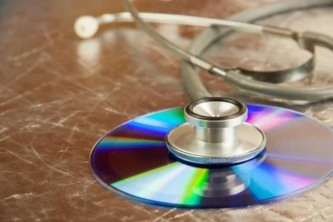 Disk CD and stethoscope Stock Photos